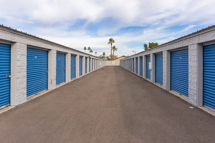 Wide drive aisle between storage units for easy vehicle access and loading
